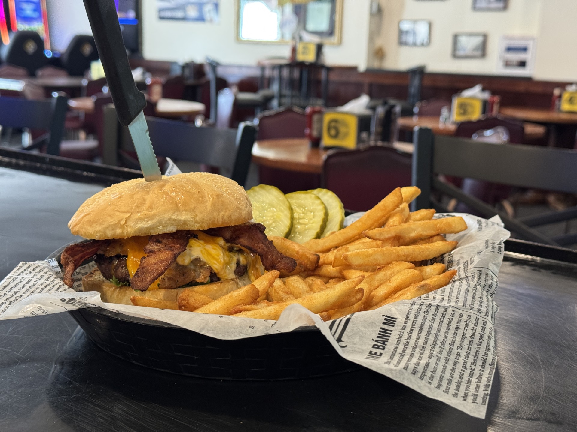 Bacon cheeseburger with fries in a basket at Pastimes